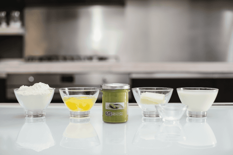 Pistì artisanal Sicilian sweets ingredients Assorted ingredients for Pistì Sicilian artisanal sweets on a white surface.