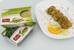 Pistachio flour package with prepared pistachio croquettes and lemon slices on a white plate.