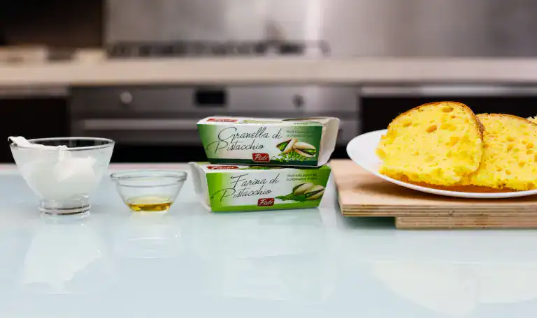 Crema di Pistacchio e pane siciliano Pistachio cream, olive oil, and Sicilian bread on a kitchen counter.