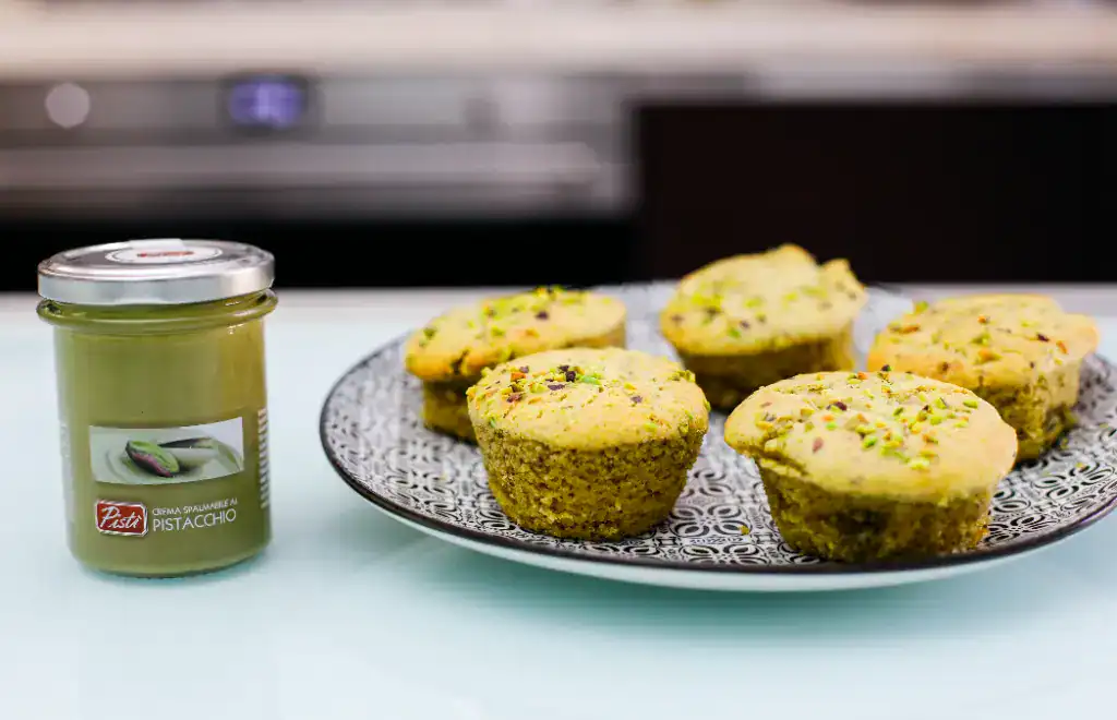 Fresh Pistachio Muffins Delicious pistachio muffins with pistachio cream jar on a plate.
