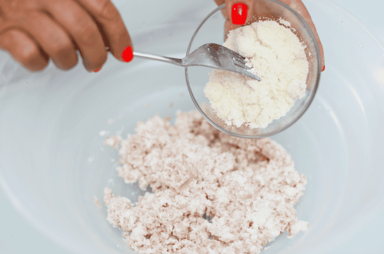 Pistì Sicilian Artisanal Sugar Preparation Hand pouring sugar into a bowl for artisanal Sicilian sweets.