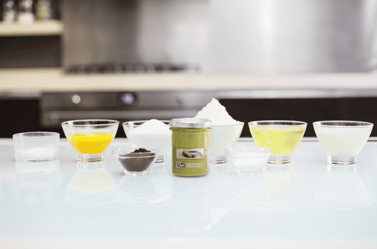 Pistì artisanal ingredients for Sicilian sweets Assorted ingredients for Sicilian sweets, including oils, powders, and liquids in small glass bowls.