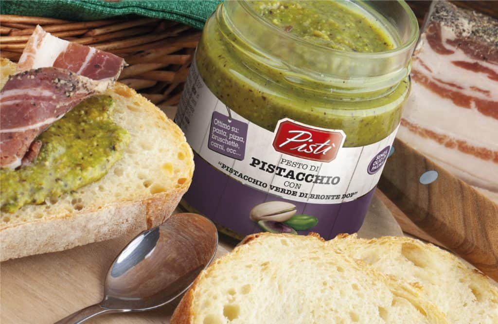 Pistacchio verde di Bronte DOP in jar with bread slices.