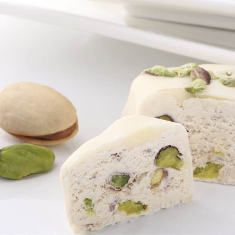 Pistachio and chocolate flavored Sicilian artisanal sweet, sliced for serving.