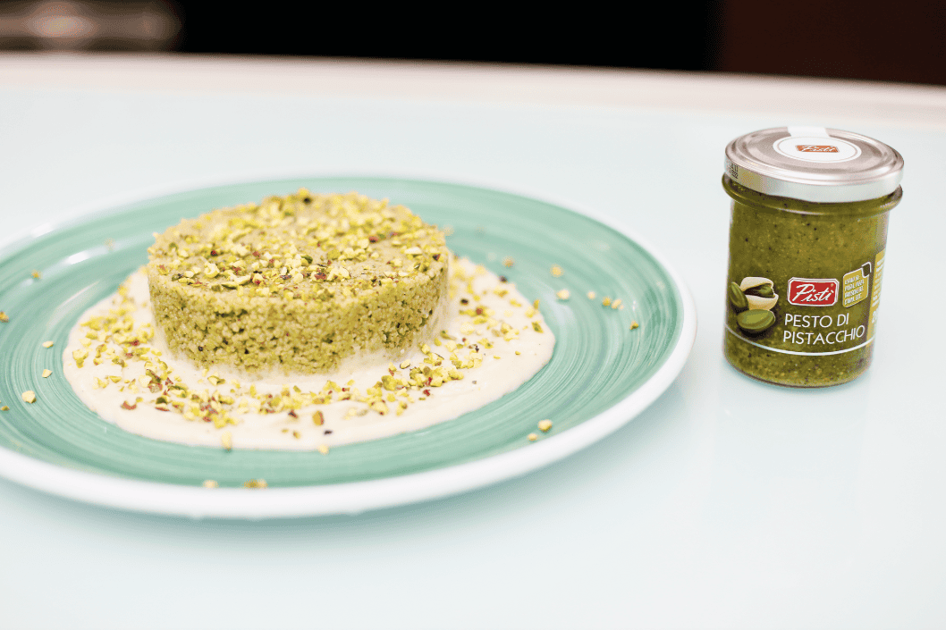 Pistachio cake with pistachio spread on the side.