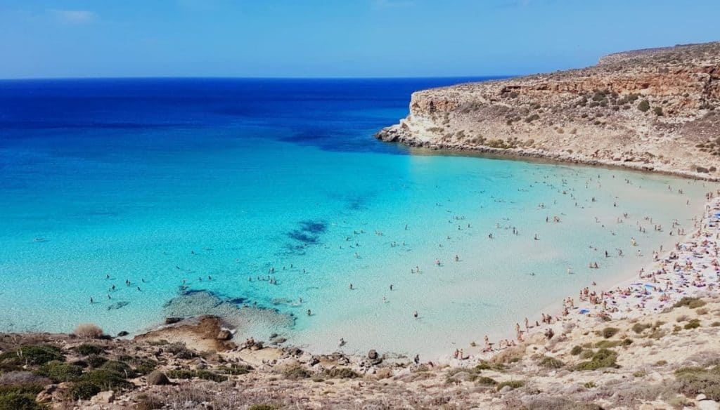 Cala Mariolu beach with turquoise waters and rocky cliffs in Sardinia.