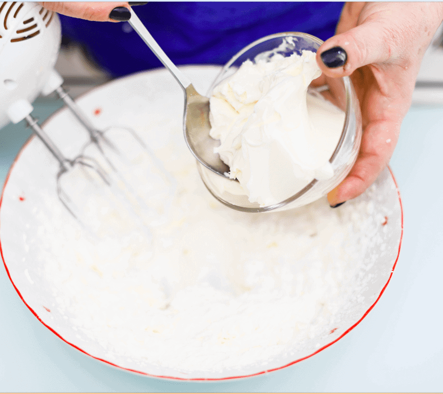 Crema di ricotta fresca Hand mixing fresh ricotta cream in a bowl with a spoon, close-up.