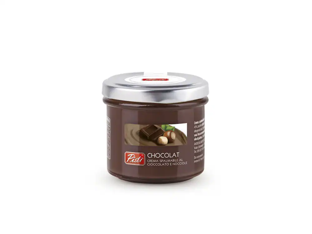 Artisanal chocolate hazelnut spread in a glass jar with a silver lid.
