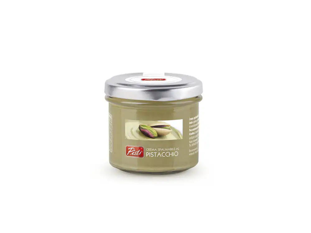 Pistachio spread in a glass jar with pistachio nuts on the label.