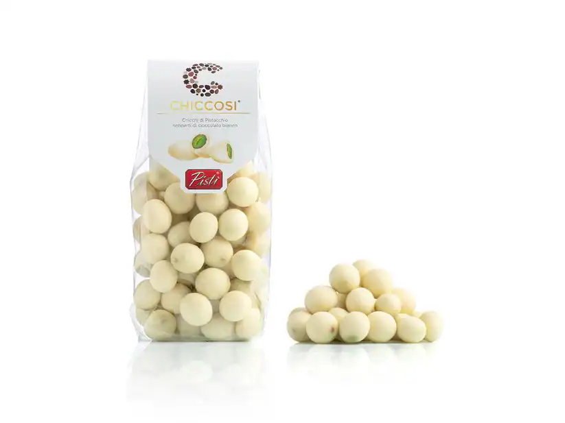 White chocolate balls in a clear bag with a pile beside it, Sicilian artisanal sweets.