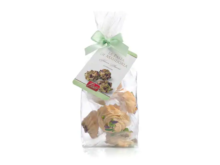 Sicilian almond sweets in clear bag with green ribbon, artisanal treat.