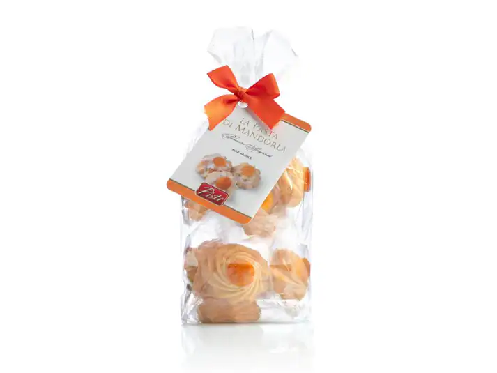 Artisanal almond sweets in a clear bag with a red ribbon, Sicilian delicacy.