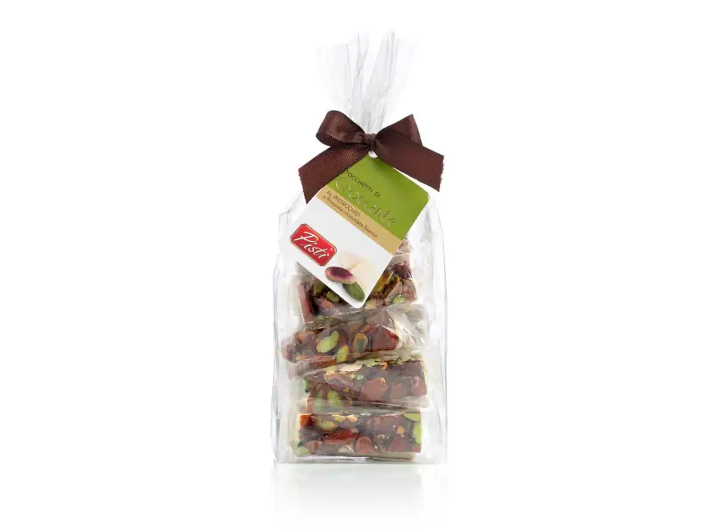 Artisanal Sicilian sweets in a clear gift bag with a brown ribbon.
