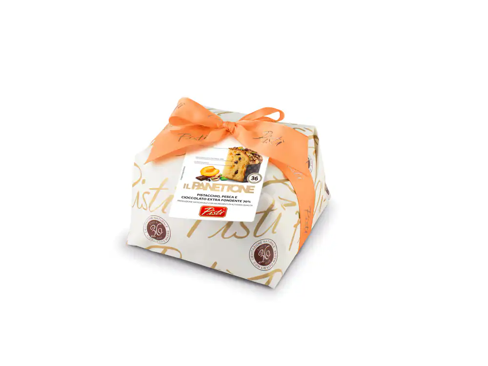 Sicilian artisanal Panettone with dried fruits, wrapped with a peach ribbon.