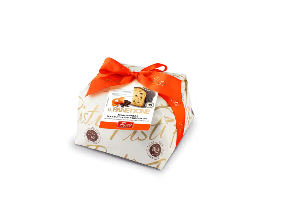Sicilian artisanal Panettone with dried fruits, wrapped with a red ribbon.