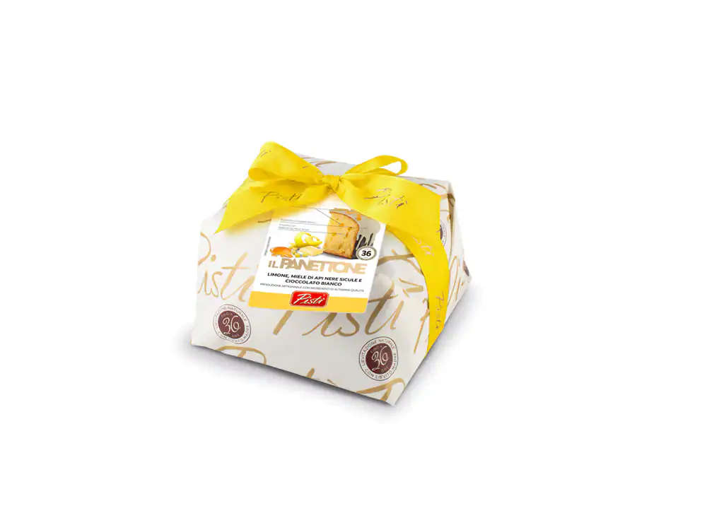 Sicilian artisanal cake wrapped in decorative paper with yellow ribbon.