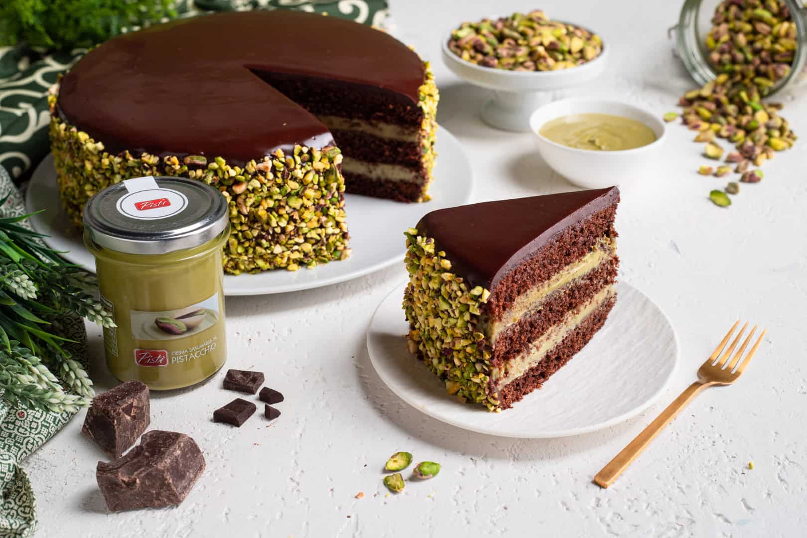 Delicious chocolate and pistachio cake with pistachio coating and layers of rich chocolate.